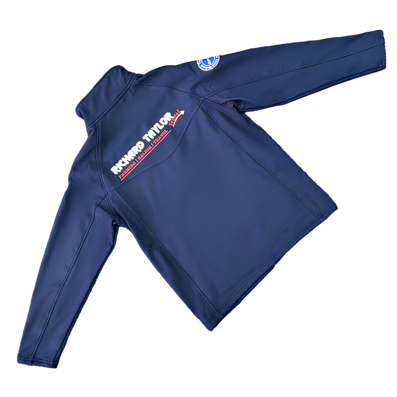 Richard Taylor Travel navy blue long-sleeve soft shell jacket with 'RICHARD TAYLOR TRAVEL' printed in white and red on the upper back, and a circular logo on the left sleeve, shown on a plain white background.