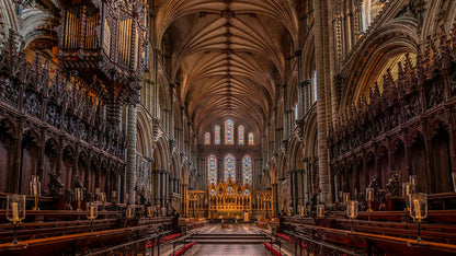 Nave of Ely Cathedral with high vaulted ceilings and stained glass windows. Ely Cathedral, known as the "Ship of the Fens," is a stunning 11th-century Romanesque and Gothic masterpiece in Cambridgeshire, famed for its unique Octagon Tower, long nave, and vibrant stained glass. The compact city centre, surrounding the cathedral, features historic streets, Oliver Cromwell’s House, and a bustling market, offering a charming mix of medieval history and modern amenities.