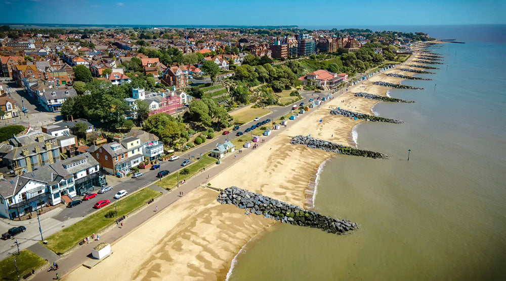 Aerial view of Felixstowe beach with houses, roads, and a beach.