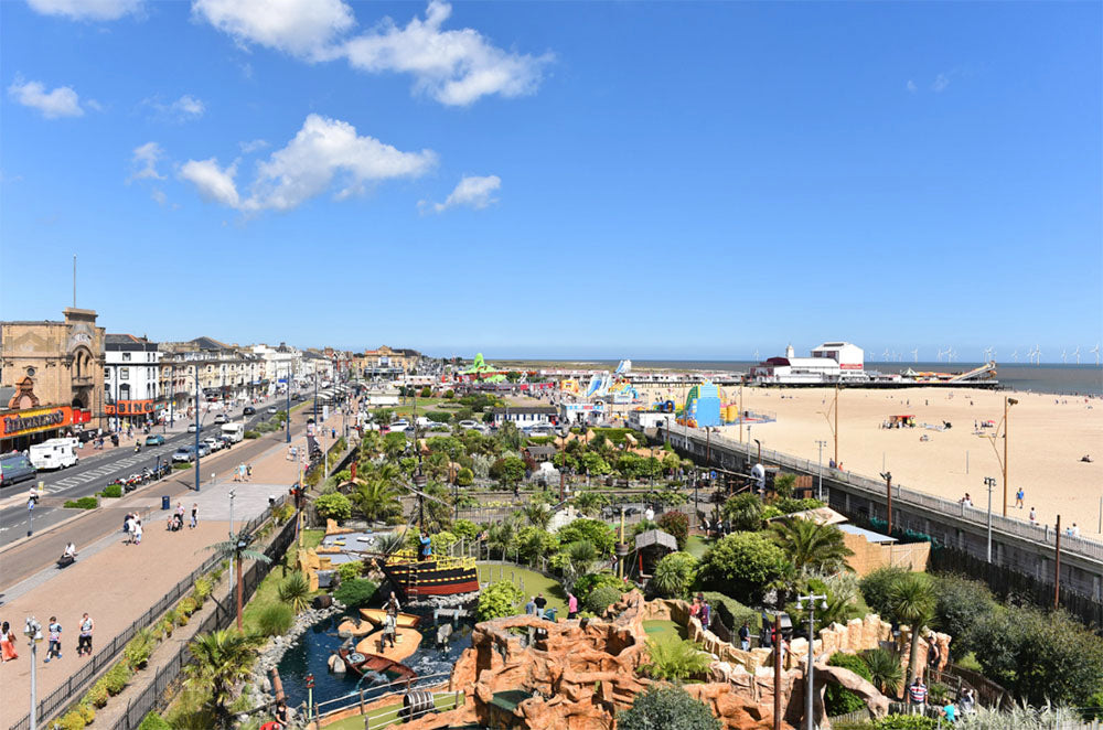 Great Yarmouth with a beach, amusements, mini golf and boardwalk under a clear blue sky