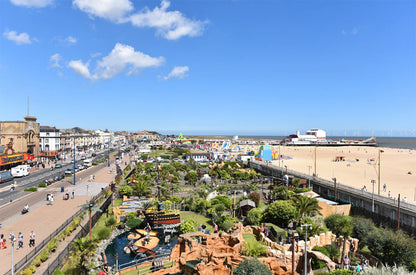 Great Yarmouth with a beach, amusements, mini golf and boardwalk under a clear blue sky