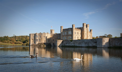 Located in Kent, England, Leeds Castle is a historic moated fortress often hailed as "the loveliest castle in the world". Built on two islands in a lake, it has served as a Norman stronghold, a royal residence for six medieval queens, and a palace for Henry VIII. It features stunning gardens, a maze, and 500 acres of parkland.