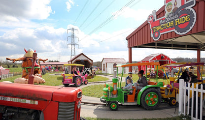 Children's amusement park with colourful tractors and a sign for 'Old McDonald's Tractor Ride'. Old MacDonald's Farm & Fun Park in Brentwood, Essex, is a popular children's farm and amusement attraction designed for families with children under 12. It features a variety of farm animals and exotic animals, including petting, feeding, and educational experiences, alongside family-friendly rides, indoor soft play, and outdoor adventure play.