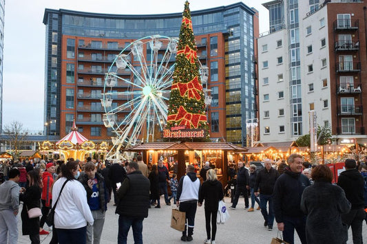Portsmouth Christmas market with a Ferris wheel and decorated tree in an urban setting