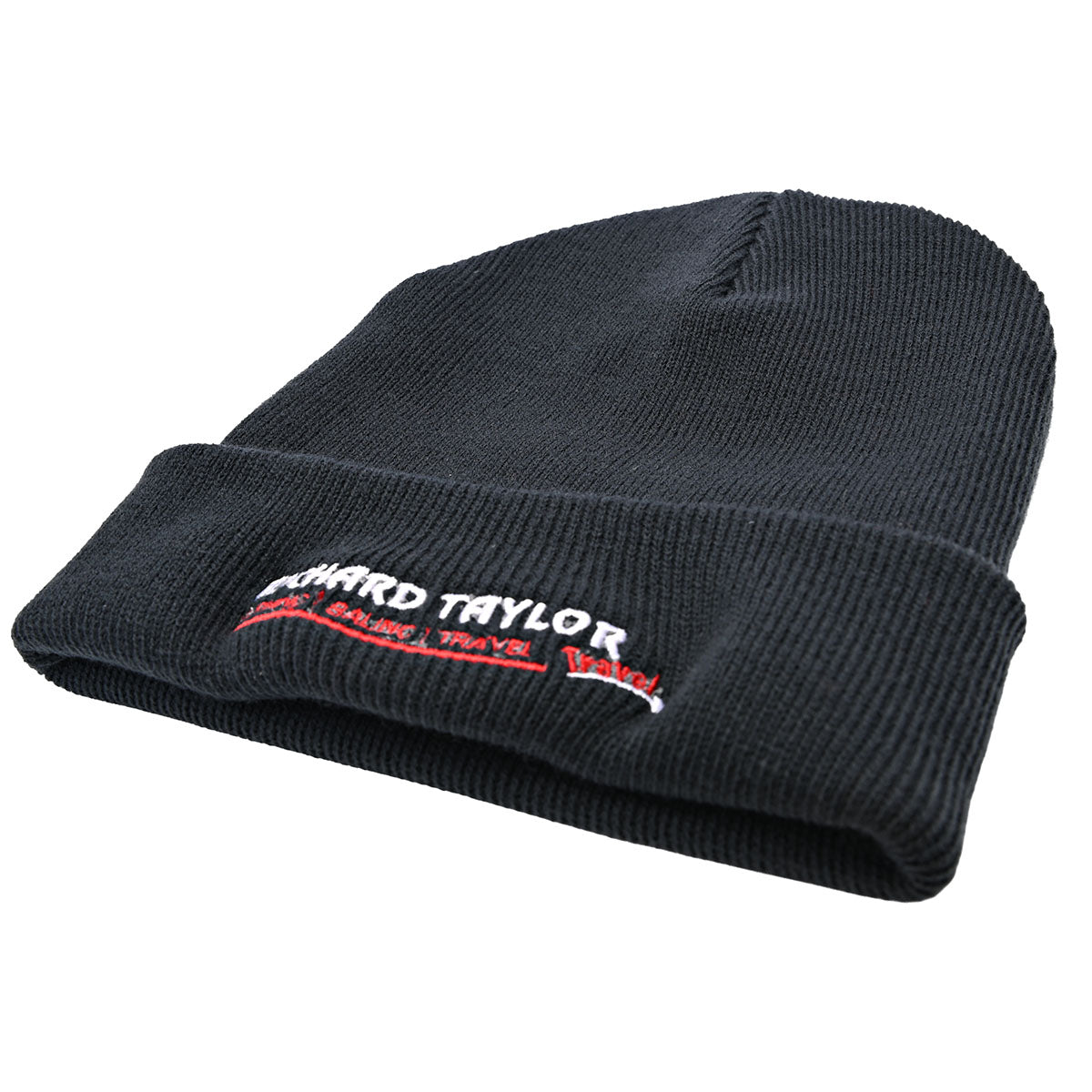 A blue ribbed knit beanie hat with a folded cuff, featuring white and red embroidered text reading 'RICHARD TAYLOR TRAVEL'  on the front cuff, shown against a plain white background.