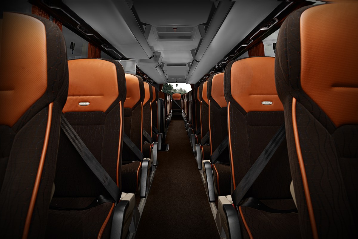 Interior of a Richard Taylor Travel Corporate Hire coach with orange and black luxury seats