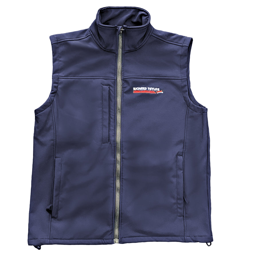 Richard Taylor Travel navy blue softshell vest with a full front zipper, high collar, and a visible 'RICHARD TAYLOR TRAVEL' logo patch on the left chest, shown against a plain white background.
