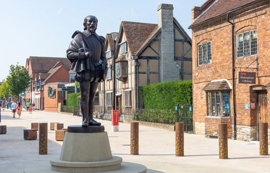 Stratford-upon-Avon features two primary Shakespeare statues in the town centre. A 2016 interactive bronze sculpture of a youthful "Young Will" sits on a bench in Bancroft Gardens, designed for photos. A second 8-foot bronze statue, erected in 2020 on Henley Street, depicts a mature Shakespeare in Elizabethan attire.