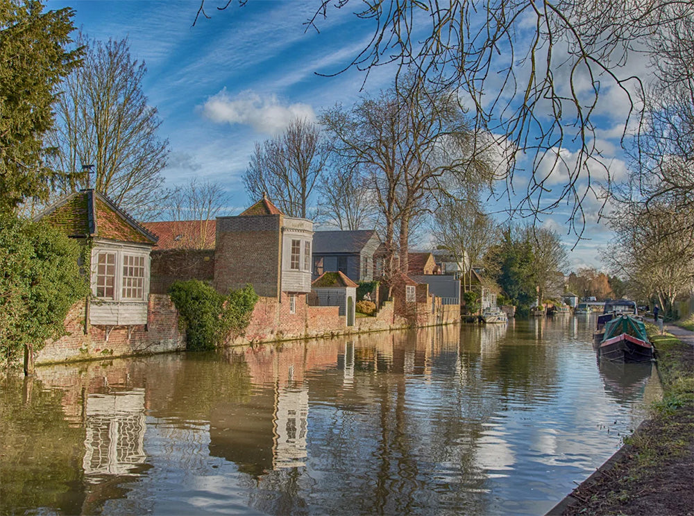 Ware canal cruise scene with houses and boats in a Ware UK.
