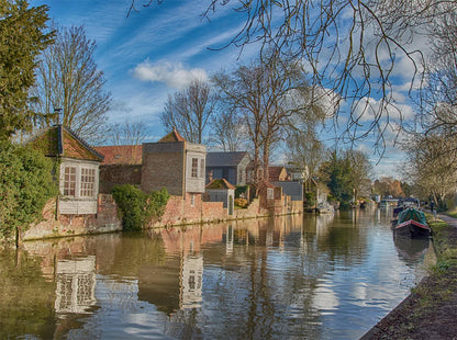Ware canal cruise scene with houses and boats in a Ware UK.