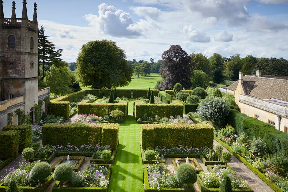 Ornate garden with manicured hedges and the Badminton Estate in the background. The RHS Badminton Flower Show is a new, major horticultural event debuting from July 8–12, 2026, on the historic Badminton Estate in Gloucestershire. It will feature RHS Artisan Gardens, over 80 specialist nurseries, live demos, and an "Allotment Borders" theme, celebrating the estate's rich gardening heritage.