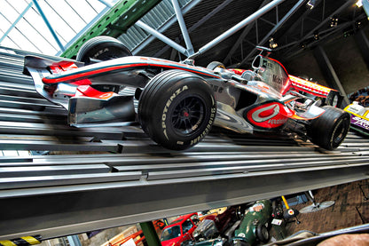 Formula 1 car on display in Beaulieu Motor Museum. The National Motor Museum at Beaulieu, located in England's New Forest, houses a world-famous collection of over 280 vehicles and motoring memorabilia, documenting British motoring history. Founded in 1952, the museum showcases iconic cars, land speed record breakers, Formula 1 machines, and classic motorcycles, alongside exhibits like "On Screen Cars" and "World of Top Gear"